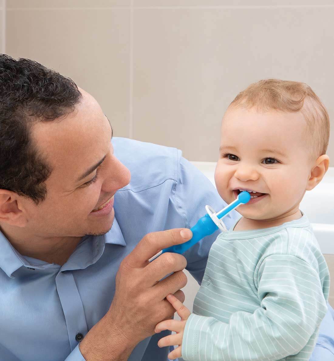 Baby boy brushing teeth with dad