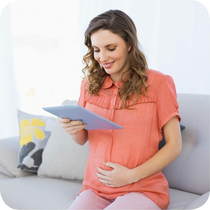 Pregnant lady reading tablet