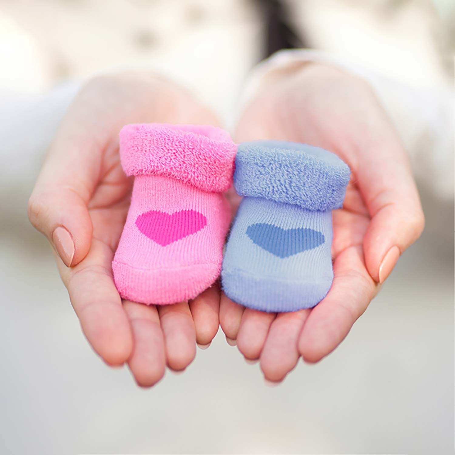 Pink and blue baby boots with heart pattern
