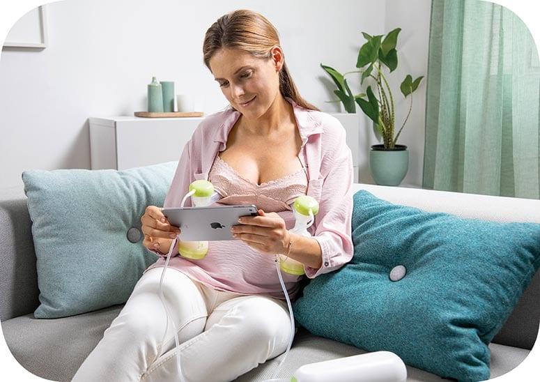 MAM Baby Double Breast Pump with lady reading tablet